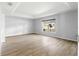 Spacious bedroom featuring recessed ceiling, large window, and light-colored wood flooring at 9287 Sw 91St Court Rd, Ocala, FL 34481