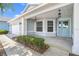 Inviting home front featuring a charming light blue front door and well-maintained landscaping at 9287 Sw 91St Court Rd, Ocala, FL 34481
