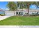 Charming single-story home features a well-manicured lawn, two-car garage, and a lovely light-blue front door at 9287 Sw 91St Court Rd, Ocala, FL 34481