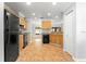 Functional kitchen featuring black appliances, light-wood cabinets, and a practical tile floor layout at 9287 Sw 91St Court Rd, Ocala, FL 34481