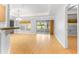 Bright living room featuring wood floors, sliding glass doors, and a neutral color palette at 9287 Sw 91St Court Rd, Ocala, FL 34481