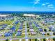 Expansive aerial view of a well-maintained neighborhood with green spaces and a new construction area on the horizon at 9677 Sw 56Th Cir, Ocala, FL 34476