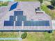 Solar panels on a roof with landscaped garden and fenced yard in an aerial view of a residential area at 9677 Sw 56Th Cir, Ocala, FL 34476