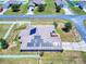 Home with solar panels on roof, nestled in a well-maintained neighborhood with fenced yards and green spaces at 9677 Sw 56Th Cir, Ocala, FL 34476