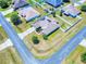 An aerial view of a neighborhood featuring a home with solar panels and a well-kept yard at 9677 Sw 56Th Cir, Ocala, FL 34476