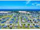 Wide aerial shot showcasing a residential community with neat streets, similar homes and a development area in the background at 9677 Sw 56Th Cir, Ocala, FL 34476