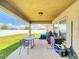 The backyard patio area features a table, grill, outdoor furniture, and access to the lawn area at 9677 Sw 56Th Cir, Ocala, FL 34476
