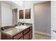 Bathroom featuring a single sink vanity and door leading to the closet at 9677 Sw 56Th Cir, Ocala, FL 34476