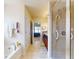 This bathroom features a combined tub and shower, and is conveniently located next to the main bedroom at 9677 Sw 56Th Cir, Ocala, FL 34476