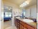 Bathroom with double sinks and a view into the bright and spacious main bedroom at 9677 Sw 56Th Cir, Ocala, FL 34476