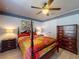 Cozy bedroom with a four-poster bed and laminate floors at 9677 Sw 56Th Cir, Ocala, FL 34476