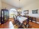 Formal dining room with wood floors, a large window, and a chandelier above the dining table at 9677 Sw 56Th Cir, Ocala, FL 34476