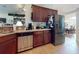 Spacious kitchen with stainless steel dishwasher and appliances, and dark wood cabinetry at 9677 Sw 56Th Cir, Ocala, FL 34476