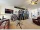 Cozy living room with carpeted floors, leather seating, and a large entertainment center at 9677 Sw 56Th Cir, Ocala, FL 34476