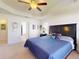 Relaxing main bedroom with a tray ceiling, ceiling fan, and ensuite bathroom and walk-in closet at 9677 Sw 56Th Cir, Ocala, FL 34476