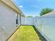 A narrow side yard is enclosed with a white vinyl fence and features a grassy area at 9677 Sw 56Th Cir, Ocala, FL 34476