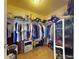 This walk-in closet offers ample storage space with organized shelving and hanging racks at 9677 Sw 56Th Cir, Ocala, FL 34476