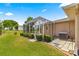 The backyard features a screened lanai, lush lawn, and mature landscaping at 9958 Sw 59Th Cir, Ocala, FL 34476