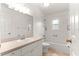 Bathroom with single sink vanity, tile floors, and combination tub and shower at 9958 Sw 59Th Cir, Ocala, FL 34476