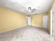 Spacious primary bedroom features tile flooring and a ceiling fan at 9958 Sw 59Th Cir, Ocala, FL 34476