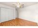 Bedroom with closet, light walls, ceiling fan and laminate wood flooring at 9958 Sw 59Th Cir, Ocala, FL 34476