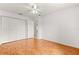 Bedroom with closet, light walls, ceiling fan and laminate wood flooring at 9958 Sw 59Th Cir, Ocala, FL 34476