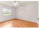 Bedroom with neutral walls, wood floors and a window offering exterior light and neighborhood views at 9958 Sw 59Th Cir, Ocala, FL 34476