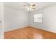Bedroom with light walls, ceiling fan and window with views of the neighborhood at 9958 Sw 59Th Cir, Ocala, FL 34476
