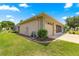 Side view of home features a well-manicured lawn and three-car garage at 9958 Sw 59Th Cir, Ocala, FL 34476