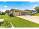 Charming single-story home with a well-manicured lawn and three-car garage at 9958 Sw 59Th Cir, Ocala, FL 34476