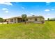 Well-maintained home exhibits a spacious front lawn with a decorative palm tree, providing curb appeal and a welcoming view at 9958 Sw 59Th Cir, Ocala, FL 34476