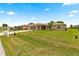 Charming single-story home features a green front yard with a decorative palm, screen enclosed patio, and inviting curb appeal at 9958 Sw 59Th Cir, Ocala, FL 34476