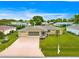 Aerial view of a single-story home with a well-maintained lawn, screened garage and driveway at 9958 Sw 59Th Cir, Ocala, FL 34476