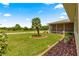 Beautiful home boasts a lush, green lawn and meticulous landscaping with a charming palm tree in the front yard at 9958 Sw 59Th Cir, Ocala, FL 34476