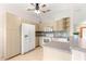 Bright kitchen featuring wooden cabinets, white appliances, and tiled backsplash at 9958 Sw 59Th Cir, Ocala, FL 34476