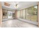 Enclosed sunroom with bright natural light, ceiling fan, and a view of the backyard at 9958 Sw 59Th Cir, Ocala, FL 34476