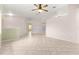 Bright and airy living room with neutral walls, tile floors, and a ceiling fan for added comfort at 9958 Sw 59Th Cir, Ocala, FL 34476