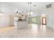 Open-concept living room with tile floors, light-colored walls, and a kitchen with modern appliances at 9958 Sw 59Th Cir, Ocala, FL 34476