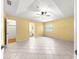 Spacious main bedroom featuring neutral tile floor, ceiling fan and en suite bathroom at 9958 Sw 59Th Cir, Ocala, FL 34476