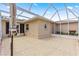 Screened in lanai with neutral color walls, ceiling, patio tiles and access to the exterior of the home at 9958 Sw 59Th Cir, Ocala, FL 34476