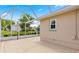 Screened in lanai with neutral color walls, ceiling, patio tiles and views of the home's back yard at 9958 Sw 59Th Cir, Ocala, FL 34476