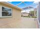 Covered patio area with a screen enclosure offering a relaxed outdoor living space at 9958 Sw 59Th Cir, Ocala, FL 34476