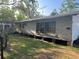 This home has a wide side yard, large picture windows, and an elevated foundation at 1004 Ne 71St Ln, Ocala, FL 34479