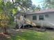 Quaint home featuring a covered porch, an expansive yard, and an elevated foundation at 1004 Ne 71St Ln, Ocala, FL 34479