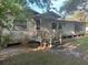Quaint home featuring a covered porch, and an expansive yard perfect for landscaping at 1004 Ne 71St Ln, Ocala, FL 34479