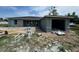 New construction of home with gray concrete exterior and a two-car garage on a partially cleared lot at 1057 Nw 68Th Pl, Ocala, FL 34474