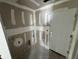 Laundry Room showcasing unfinished drywall, hookups, and a white exterior door at 1057 Nw 68Th Pl, Ocala, FL 34474