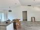 Bright and airy living room with modern lighting, gray wood-look flooring, and white walls at 1057 Nw 68Th Pl, Ocala, FL 34474