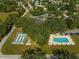 Community aerial showing the pool and shuffleboard amenities, clubhouse, parking and lovely shade trees at 11245 Sw 63Rd Terrace Rd, Ocala, FL 34476
