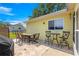Brick patio with outdoor seating and a yellow house exterior at 11245 Sw 63Rd Terrace Rd, Ocala, FL 34476